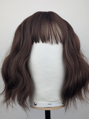 This bob has very loose tousled waves. A dark brown shade from roots to tips. With a sleek blunt fringe.