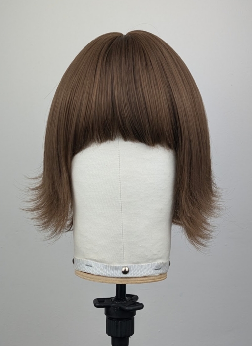 Outlet #159 - Lush Wigs UK This jaw-skimming bob, styled with a gentle flick curl at the ends. Short choppy layers add volume. With a sleek light fringe. A colour mix of warm light browns from roots to tips. Easy to wear and maintain.