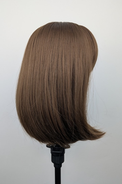 This natural brown colour wig is simple and easy to wear. Its rich brown shades come to life with golden-copper undertones. A sleek long bob (lob) that curls just under at the ends. With a light sleek fringe.