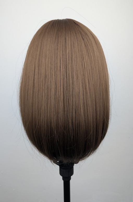This natural brown colour wig is simple and easy to wear. Its rich brown shades come to life with golden-copper undertones. A sleek long bob (lob) that curls just under at the ends. With a light sleek fringe.