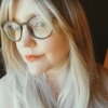 Lilly is a soft and natural warm chestnut tone from roots to tips. A graduated cut that curls under, falling just below the jawline, with a sleek blunt fringe. A simple yet stylish cut that’s easy to maintain.
