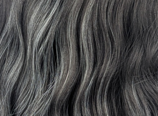 This long bob wig is styled into a loose wave. With a sleek blunt fringe. A very dark brown colour, defined with platinum blonde high-lights.  
