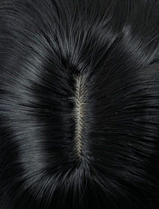 A very dark brown colour from roots to tips. Styled in loose waves that fall to the waist. Long invisible layers to add body and movement to the look. With a sleek blunt fringe.