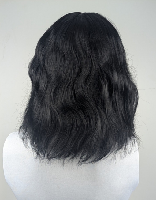Black Tea is a natural one length bob styled in tousled waves that give plenty of volume and texture. Black from roots to tips with a blunt fringe.