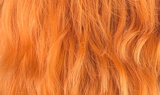 A pixie cut in a ginger colour. Sleek layers on top with a slight textured finish to add some lift and volume. Wear it forward or swept to the side away from the face.