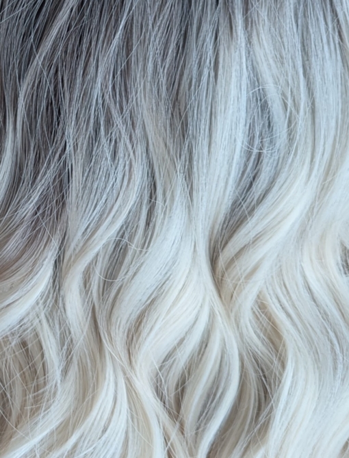 Ice Tea - Lush Wigs UK A wig with brown shadowed roots that grow into this platinum blonde icy hue. Styled into a bob with loose waves. The fringe is sleek and blunt.