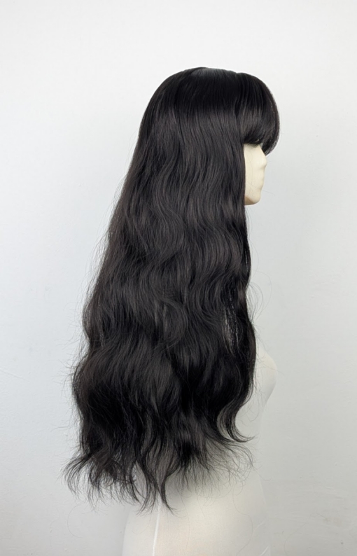 A very dark brown colour from roots to tips. Styled in loose waves that fall to the waist. Long invisible layers to add body and movement to the look. With a sleek blunt fringe.