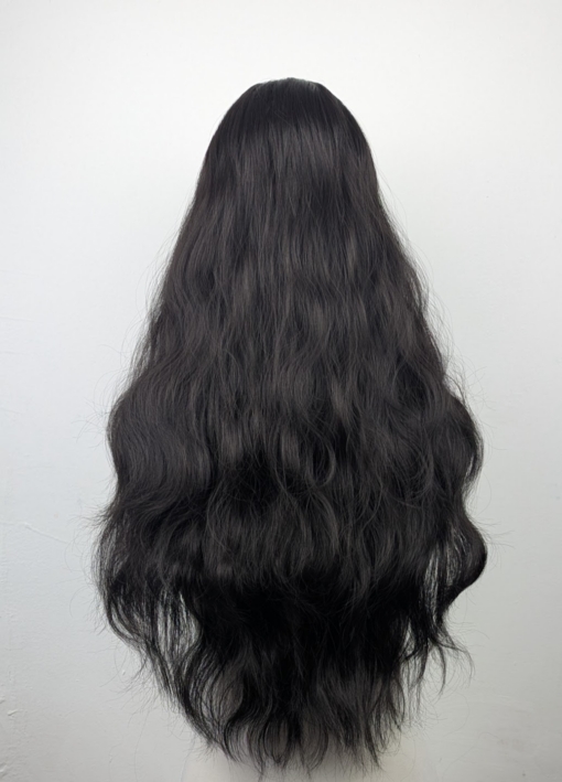 A very dark brown colour from roots to tips. Styled in loose waves that fall to the waist. Long invisible layers to add body and movement to the look. With a sleek blunt fringe.