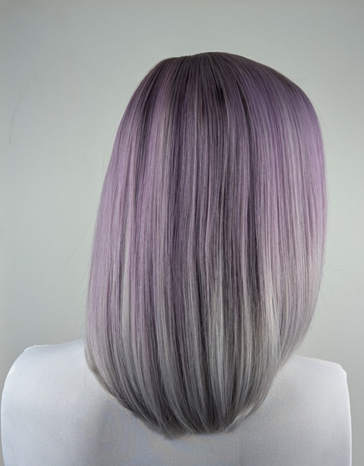 A beautiful tricolour style ombre. From light brown roots to lilac and grey mix, finished with a dip dye pearly grey colour. It's cut into a long sleek bob with layers making this style easy to maintain. A light blunt fringe finishes the look.
