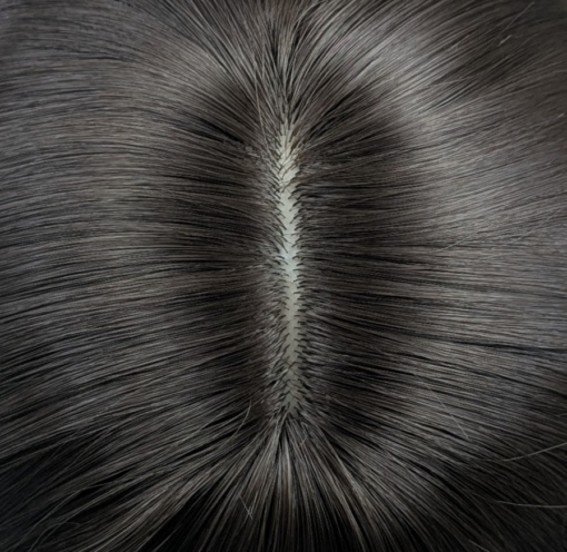A sleek straight style in a natural chestnut colour. With long layers cut in and a blow out style to add fullness and movement. With a sleek blunt fringe.