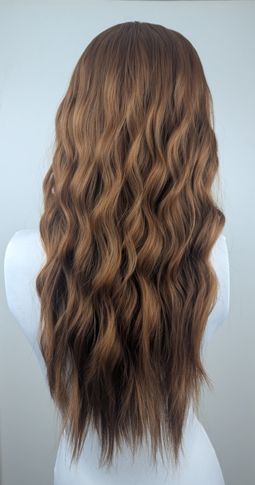 Tabitha - Lush Wigs UK A natural fringeless wig with a golden brown hue from roots to tips. Long lengths are styled into a relaxed flat iron wave. That leaves the ends of the hair sleek.