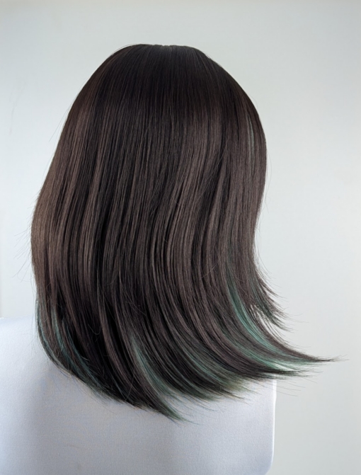 This dark brown and sage green wig has the best of both worlds. From the roots and fringe are a dark brown. Underneath lies a sage green for a peek-a-boo effect. Styled into a long sleek bob with layers for added volume.