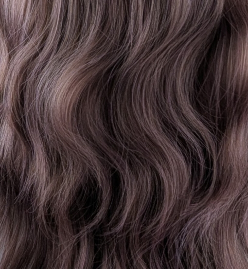 Yoake - Lush Wigs UK This wig has brown shadowed roots that blend into a mix of warm chocolate browns and dark pinks. They create this beautiful rosewood colour. Styled in a loose wave with subtle layers. The light fringe is sleek and blunt.