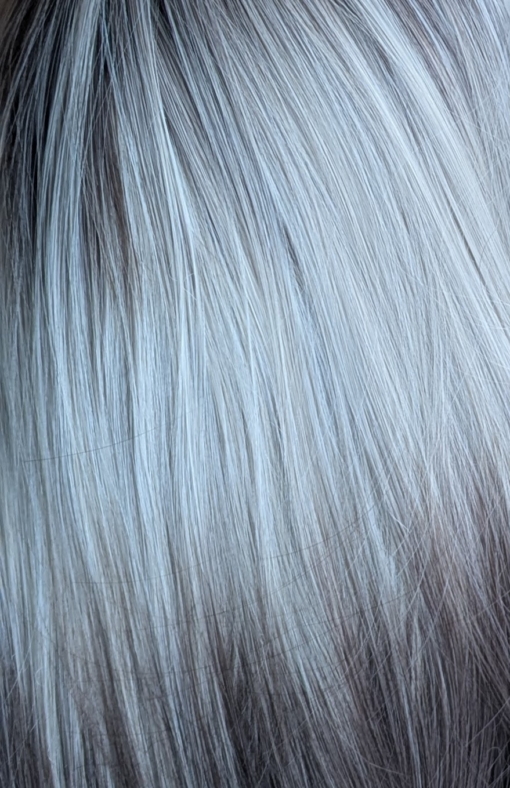 Argene - Lush Wigs UK A sleek natural long bob (lob) with a light fringe. Carries dark brown shadowed roots that blend into this pearl blonde colour with silvery grey undertones. Finished off with a block of chocolate brown at the tips.