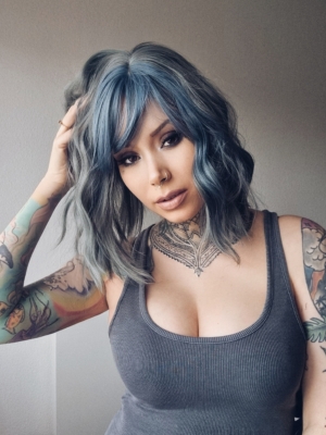 Deep Sea - Lush Wigs UK This long bob styled into flat iron waves comes in a mix of dark green and denim blue. Resulting in a wash out effect on colour. A block of blue colour frames the face. The fringe is sleek.