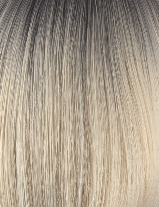 Atonia - Lush Wigs UK This platinum blonde wig has dark brown shadowed roots for a natural feel. Styled sleek that slightly curls under at the ends. Cut into a jaw skimming bob with a sleek blunt fringe.
