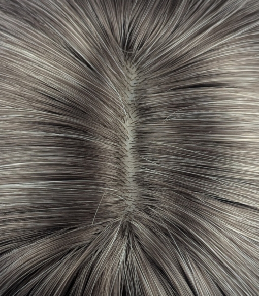 Atonia - Lush Wigs UK This platinum blonde wig has dark brown shadowed roots for a natural feel. Styled sleek that slightly curls under at the ends. Cut into a jaw skimming bob with a sleek blunt fringe.