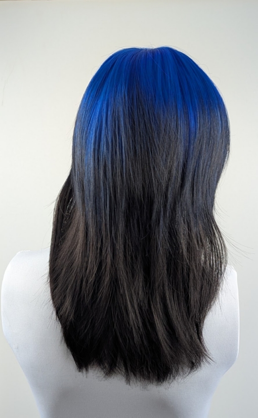 Azure - Lush Wigs UK This glam rock throwback shaggy cut sleek style has blue roots and a full blue fringe. Cool black tone with a peek a boo of blue from the nape of the neck.