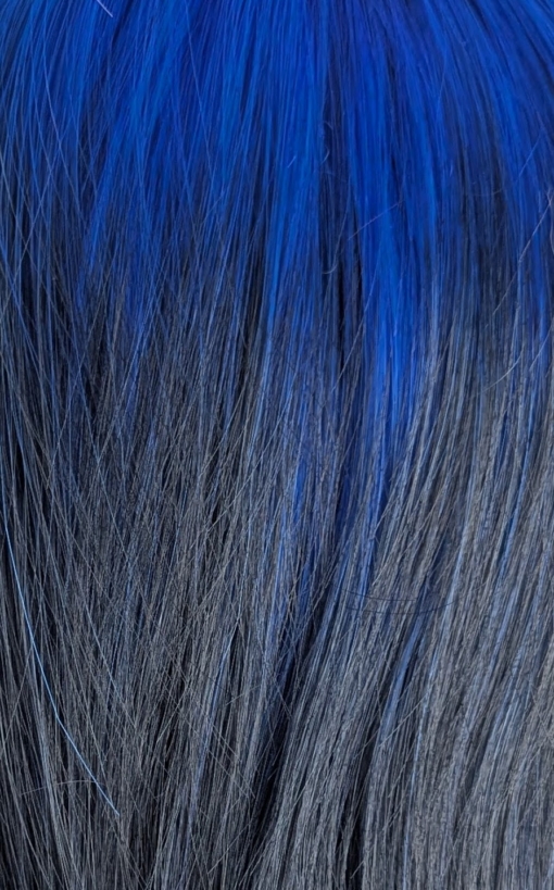 Azure - Lush Wigs UK This glam rock throwback shaggy cut sleek style has blue roots and a full blue fringe. Cool black tone with a peek a boo of blue from the nape of the neck.