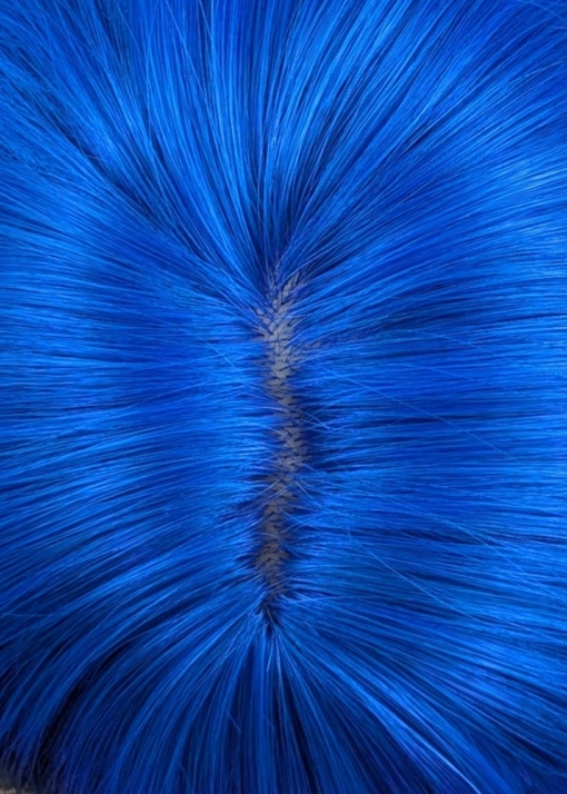 Azure - Lush Wigs UK This glam rock throwback shaggy cut sleek style has blue roots and a full blue fringe. Cool black tone with a peek a boo of blue from the nape of the neck.