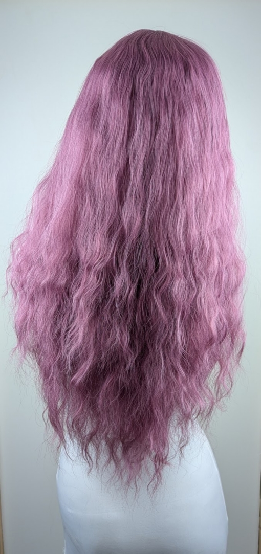 Bloom - Lush Wigs UK A wig a deep lilac pink hue from roots to tips. Think of braids let loose to create mermaid waves that falls to the waist. The long sleek fringe is blunt.