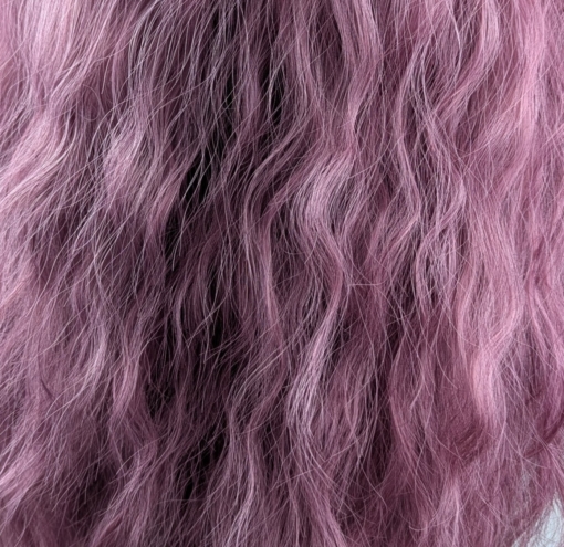 Bloom - Lush Wigs UK A wig a deep lilac pink hue from roots to tips. Think of braids let loose to create mermaid waves that falls to the waist. The long sleek fringe is blunt.