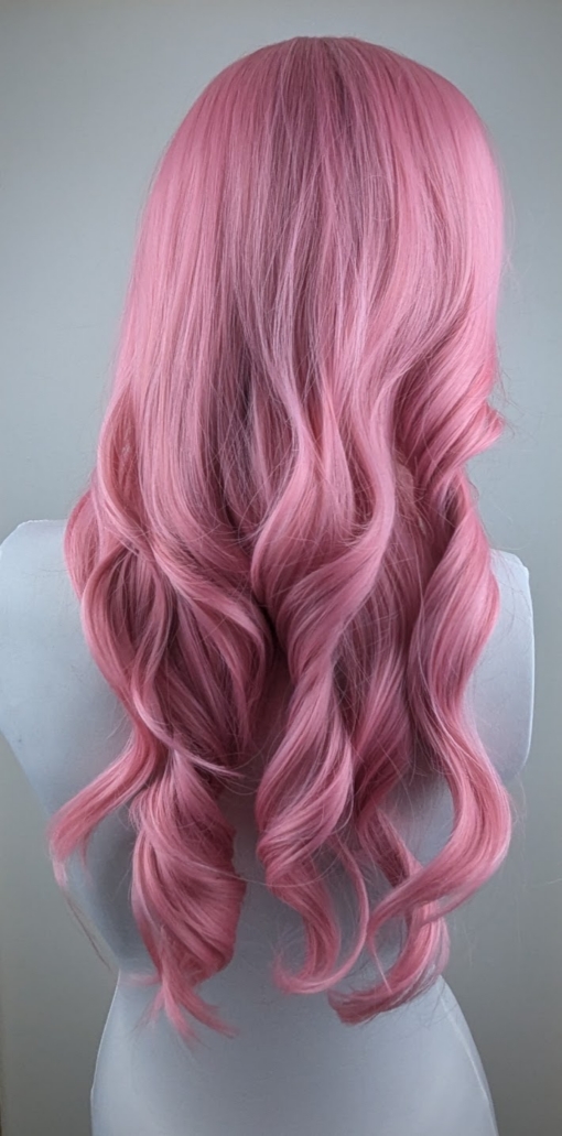 Bubblegum - Lush Wigs UK Pink from roots to tips. A blend of light pink and white stands of hair make this rose pink colour, from roots to tips. Styled in waves that fall to the waist. The light fringe finishes the look.