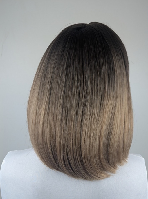 Cedar - Lush Wigs UK This earthy natural wig with light brown roots that blend into a dark blonde ombre. A simple sleek sleek style that curls under just at the ends. Complete with a light sleek blunt fringe.