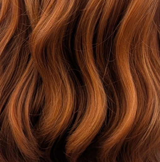 This wig has brown shadow roots that blend into a natural warm mix of copper and auburn tone. Styled in loose barrel curls falling to the waist. The fringe is sleek and blunt.