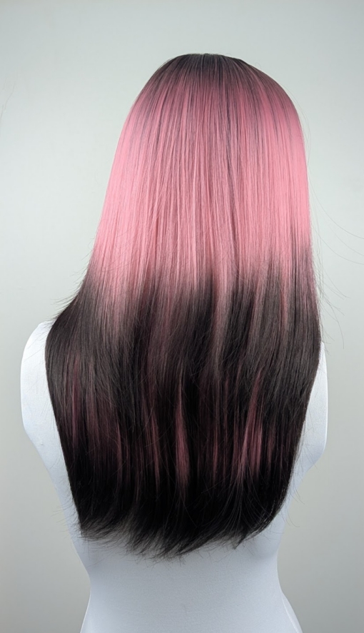 Dusk - Lush Wigs UK This Reverse Ombré natural twist wig is perfect for a subtle pop of colour. Soft black roots blend into a dusky pink hue with black ends. A sleek style with long layers at the back. With a full blunt fringe.