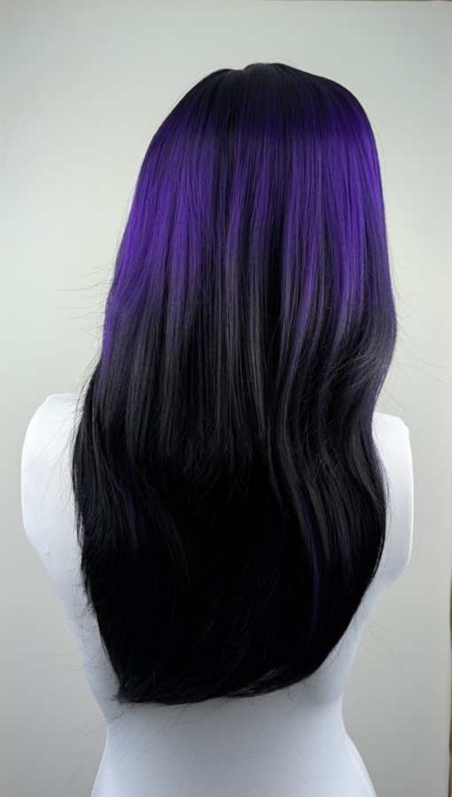 This Reverse Ombré natural twist of soft black and a deep purple pop of colour. Soft black roots blend into this purple hue with black tips. A sleek long style with long layers at the back that have a blow out look. Face framing layers at the front make this style easy to maintain. With a full sleek blunt fringe.
