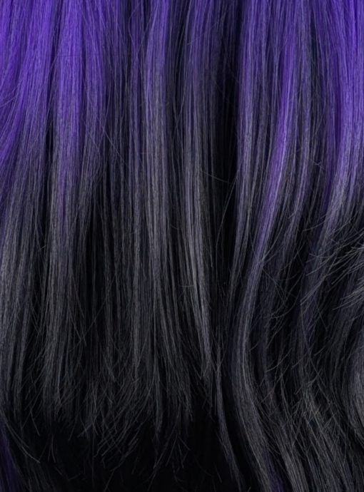 This Reverse Ombré natural twist of soft black and a deep purple pop of colour. Soft black roots blend into this purple hue with black tips. A sleek long style with long layers at the back that have a blow out look. Face framing layers at the front make this style easy to maintain. With a full sleek blunt fringe.