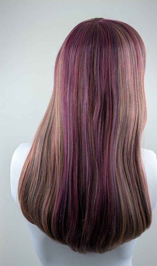 This Vivid wig is a mixture of purples, blues and muted lemon and green tones, from roots to tips. Styled sleek with long layers falling to the waist. The fringe is long and sleek, wear it to the side or parted for curtain bangs.