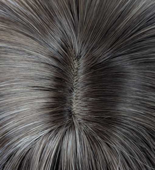 January - Lush Wigs UK A natural wig with dark brown shadow roots that blend into a mix of platinum blonde and sandy blonde. These two tones blend to create a mushroom hue.The ends of the hair are pure platinum blonde. The style is long and sleek with layers at the front with a blunt fringe.