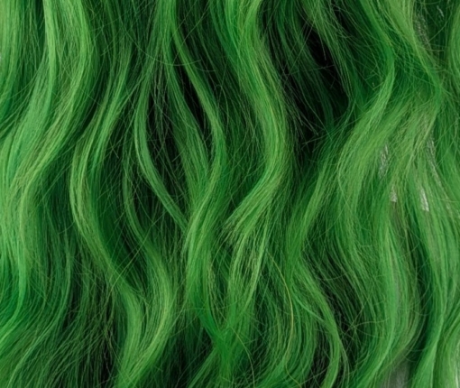Lagoon - Lush Wigs UK Green and bold. Dark brown roots blend into this bright two tone green colour, with a slice of dark brown at the nape of the neck. For a peek-a-boo effect. Styled into a loose wave with a blunt fringe.