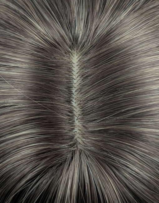 This natural wig is simple but its twist on colour adds some dimension. A sleek long bob (lob) with a light blunt fringe. Dark brown shadowed roots blend into this light blonde colour, finished with a block of dark brown at the tips. A natural mix of colour that sets this look.