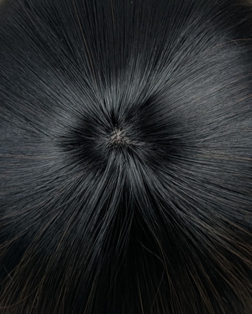 Lucia is a sleek bob that curls under at the ends. Falling to the jawline. This black/brown colour has highlights of copper tones that bring it to life. With a sleek full blunt fringe.
