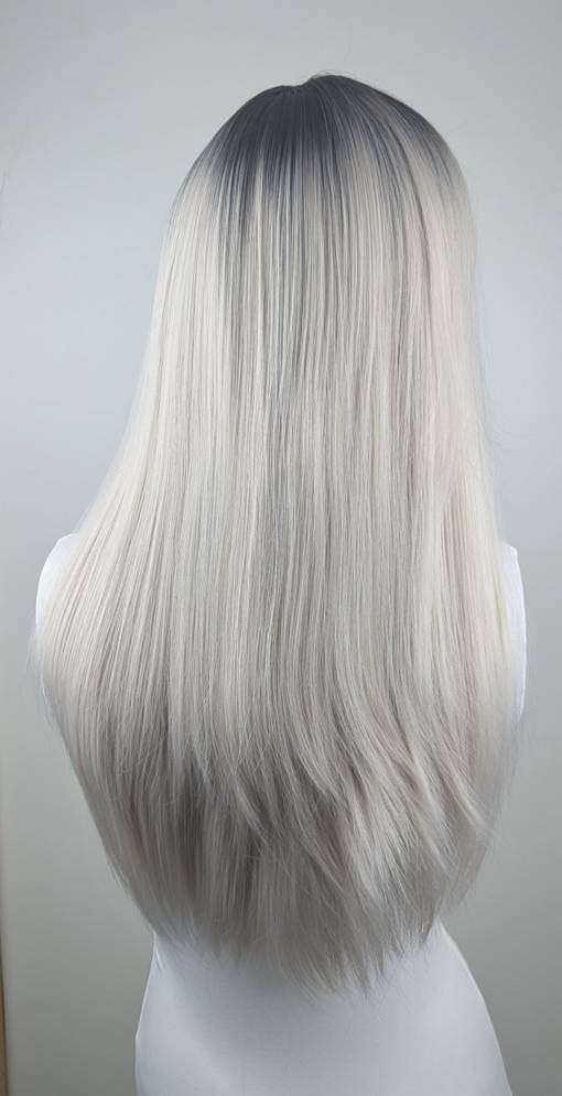 Maddy - Lush Wigs UK Dark brown shadowed roots blend into a sterling blonde colour. Cut into long straight layers to add fullness and movement. A blunt sleek fringe finishes the look.