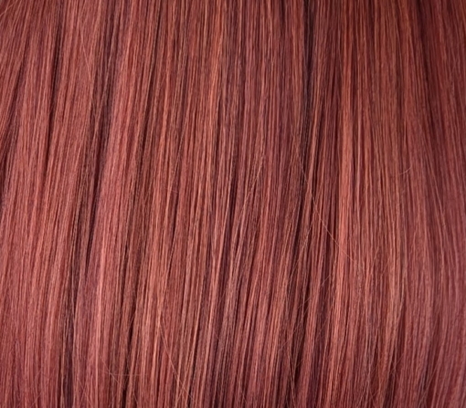 Mantle - Lush Wigs UK Long and sleek with layers and styled in a blowout. A rich russet auburn with ginger undertones creates this colour from roots to tips. A long full fringe adds volume.