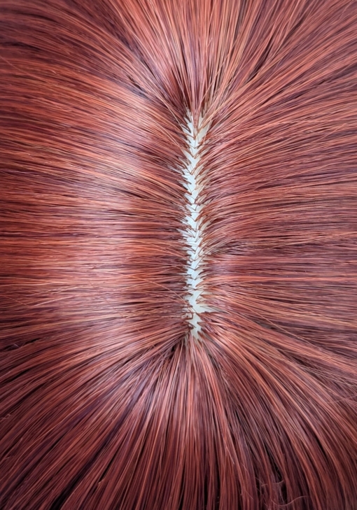 Mantle - Lush Wigs UK Long and sleek with layers and styled in a blowout. A rich russet auburn with ginger undertones creates this colour from roots to tips. A long full fringe adds volume.