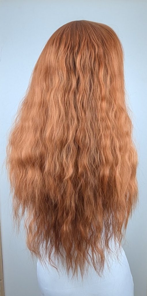 Marmalade - Lush Wigs UK This natural ginger colour from roots to tips. Made up of copper and amber tones. Styled in crimped mermaid waves in layers that fall to the waist. With a blunt sleek fringe.