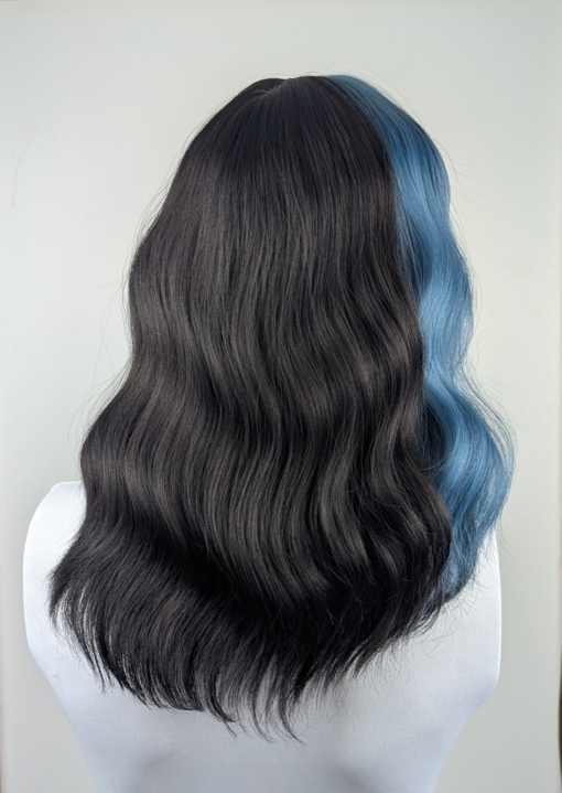 This wavy dark brown bob comes to life with a face framing peek-a-boo slice of denim blue colour. Thats carried into the blunt sleek fringe.
