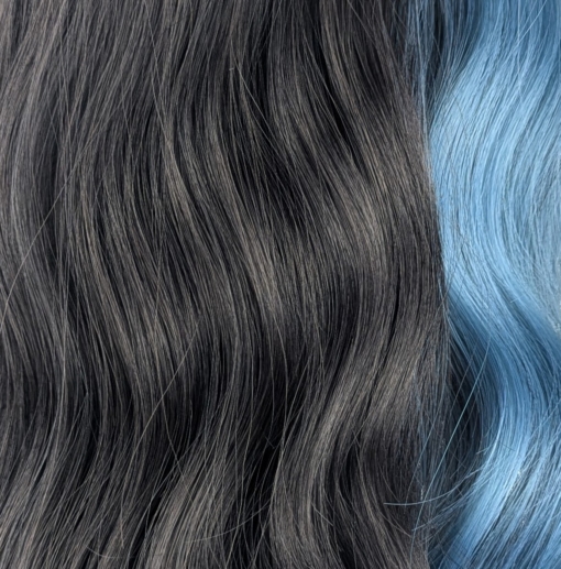 This wavy dark brown bob comes to life with a face framing peek-a-boo slice of denim blue colour. Thats carried into the blunt sleek fringe.