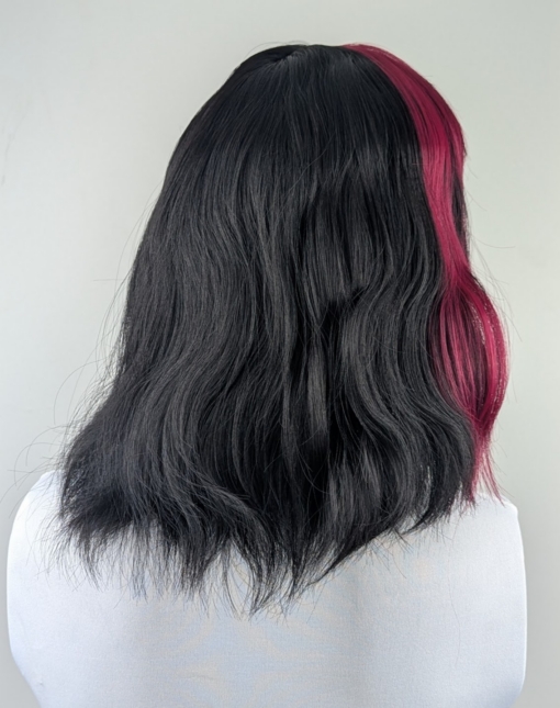 Myth - Lush Wigs UK This wavy bob comes to life with a face framing slice of bright purple colour. Thats carried into the sleek fringe and adds a peek-a-boo at the sides. A soft black colour from roots to tips.