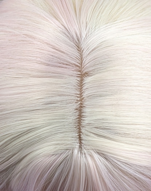 This long style comes in three shades of pastel lilac and peachy pink. Styled into waves. Blonde roots give a natural feel to the style finished with a sleek blunt blonde fringe.