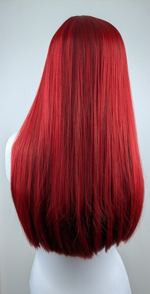 A rich, jewel toned ruby red from the roots to tips. The cut is long with invisible layers and dead straight with a full blunt fringe. 