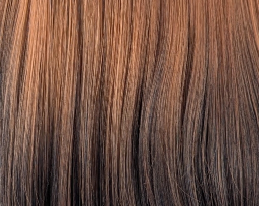 Rosaleen - Lush Wigs UK This natural wig with dark brown roots blend into this copper ginger hue with dark brown ends. A sleek medium length style with long layers at the back. Face framing layers at the front make this style easy to maintain. A blunt sleek fringe frames the face.