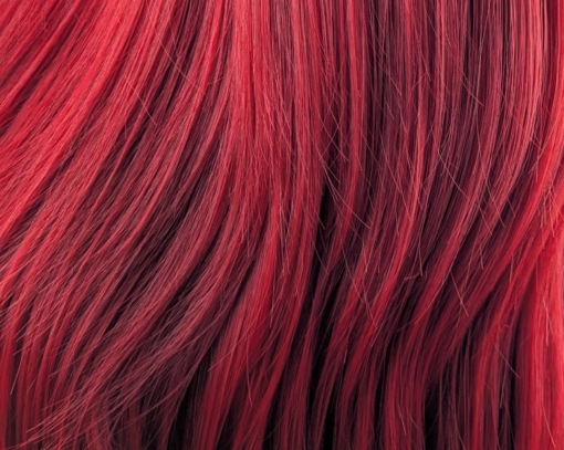 This sleek style comes in a vivid fire engine red colour from roots to tips. Cut into long layers that fall to the waist. Finished in a barrel brush blow out, with a sleek blunt fringe.