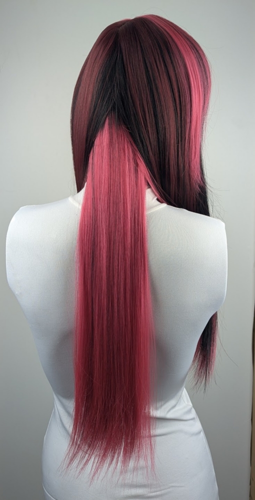 Stitch - Lush Wigs UK This wig is cut into face framing layers with a sleek blunt fringe. A long style with a slice of dark pink at the front. Mixed in with a natural warm black tone to the rest of the head. A block of pink colour from the nape of the neck gives a peek-a-boo effect.