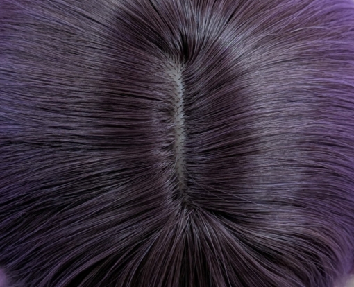 This wig has brown shadowed roots that melt into a dark lilac colour into a soft pink ombre. A bob styled into loose waves with a sleek blunt fringe.